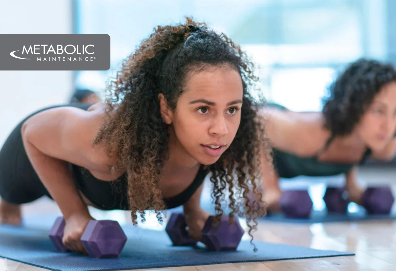 Woman in a push-up position on a mat with purple dumbbells nearby and Metabolic Maintenance branding.