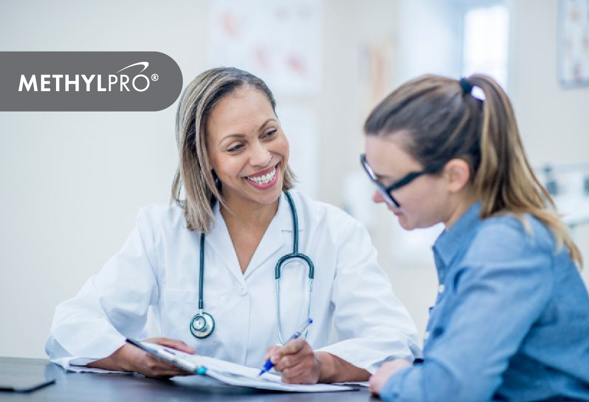 Medical professional in white coat with stethoscope consults a patient in a clinic, MethylPro logo in the corner.