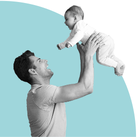 Man lifting a baby above his head against a light blue background