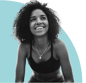 Smiling woman with curly hair looking upward, set against a soft blue abstract background.