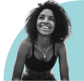 Woman with curly hair smiling against a light blue background