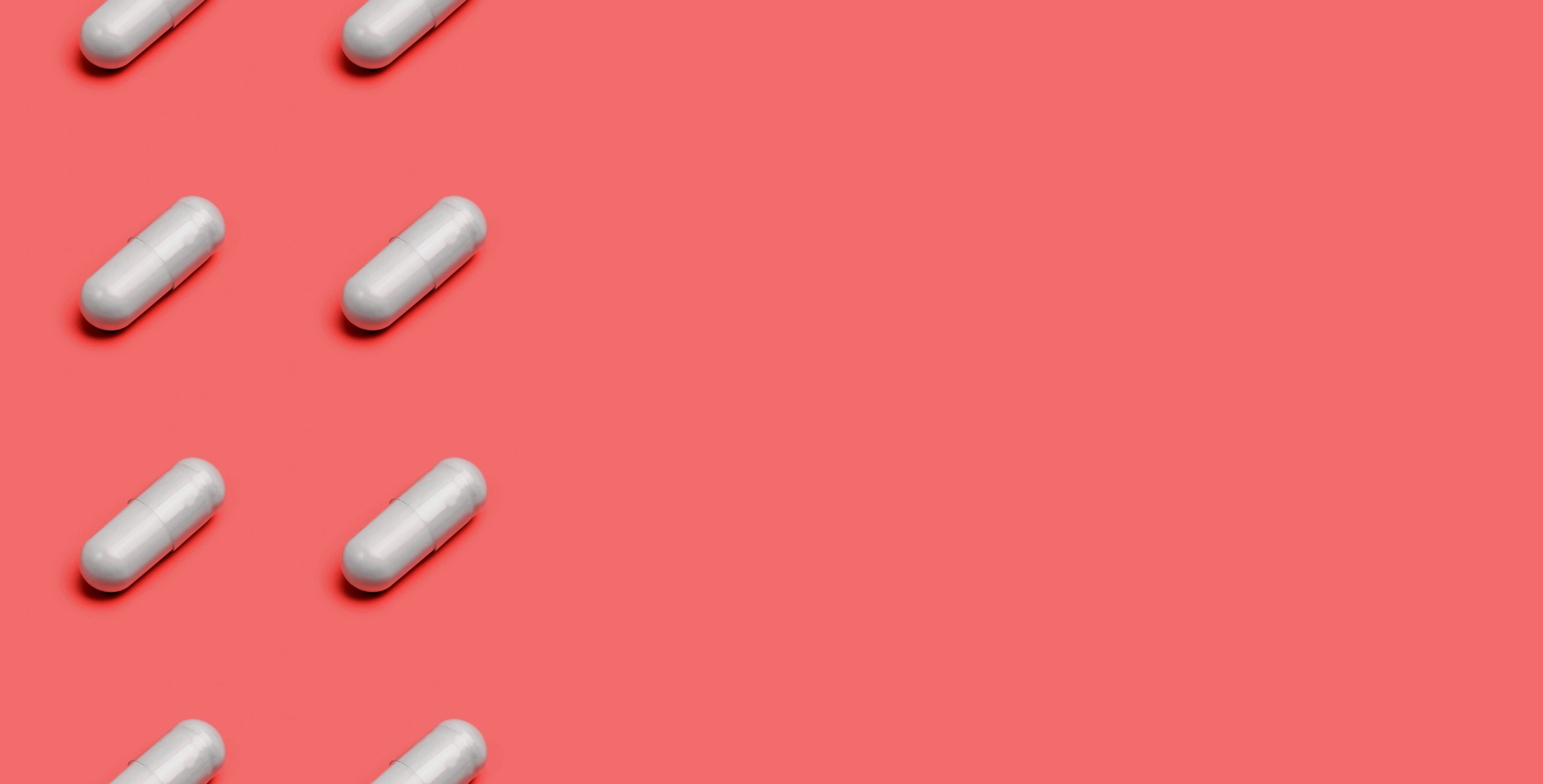 White capsules on coral background – visual collage for wellness or supplement branding