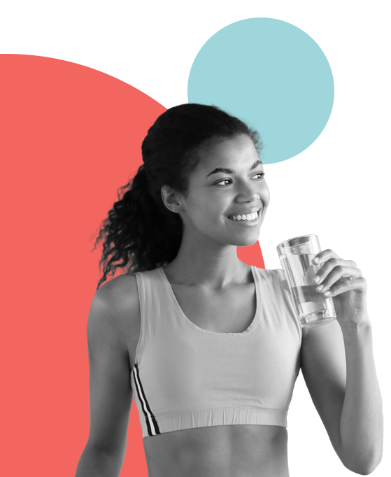 Young woman in activewear holding a glass of water – lifestyle image related to supplements or wellness